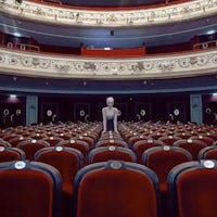 an empty auditorium with a mannequin standing in the middle