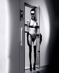 a mannequin in black and white standing in a doorway