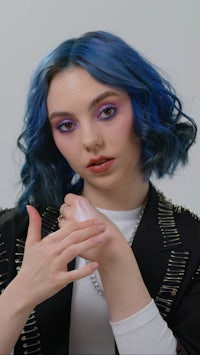 a woman with blue hair posing for a photo