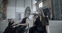 a woman in a wheelchair is holding a megaphone